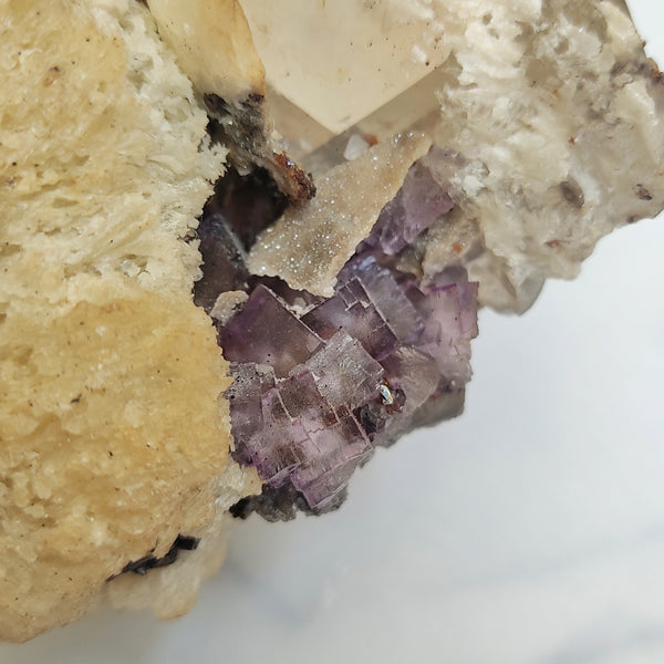 Elmwood Calcite specimen with purple Fluorite and Sphalerite on a Baryte sphere